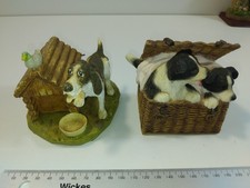 Two Figurines Of A Springer Spaniel And Border Collies In A Wicker Basket