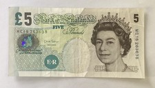 Five pound note used - note, used/salmon