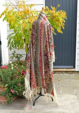 AN ANTIQUE VICTORIAN PRINTED WOOL SHAWL WITH FRINGING