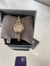 guess ladies watch with gold strap diamonte face and detail