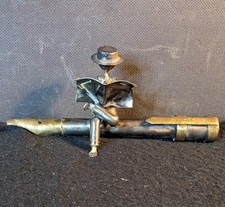 Small Metal Sculpture Of A Man Sitting On A Fountain Pen Reading A Newspaper