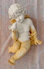 large resting cherub with bird