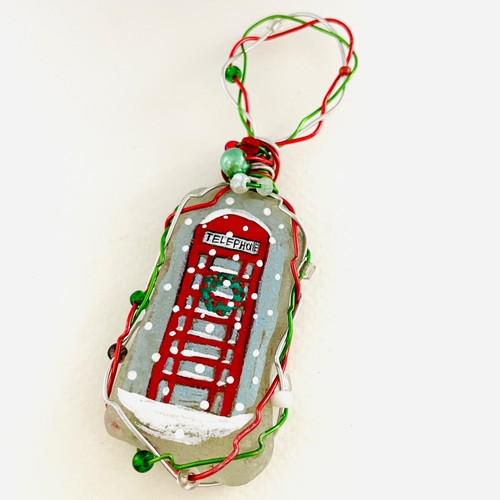 Red telephone box - sea, glass