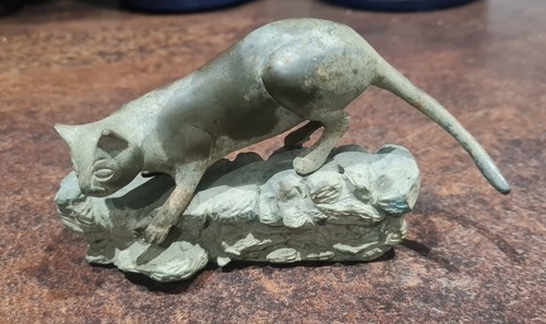 Bronze cat figurine dry - on,