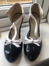 ladies black and white patent shoes with a platform sole and 4 inch heel