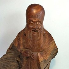 Wooden smiling old man statue