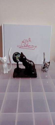 Bronze looking glass cat - looking,