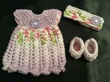Hand knitted dolls clothes to