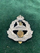The East Lancashire Regiment King's Crown KC Bi-Metal cap badge with slider.
