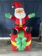 large inflatable christmas decorations Santa On A Present