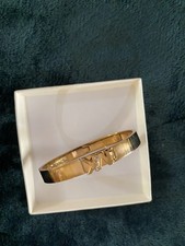 1  Gold Tone Michael Kors. Bracelet.