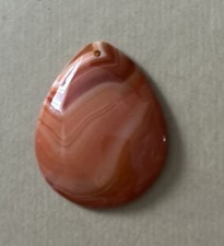 Polished, teardrop-shaped agate cabochon,  carnelian or sardonyx, pendant. 