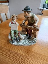 Old man and boy figurine