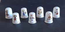 Collection of 7 Fenton China Company Children of the Week Thimbles