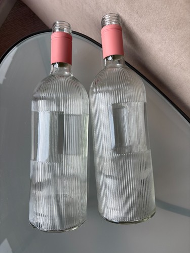 Two empty pretty - pretty, bottles