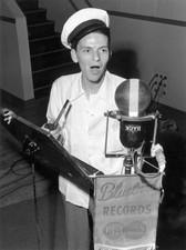 Frank Sinatra stands next to a