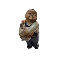 Comical Chinese 'Mudman' figure from the Shiwan ware tradition.
