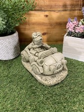 STONE GARDEN FROG IN A CAR