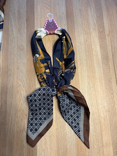 This elegant scarf features - , a