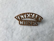 VETERANS CORPS BRASS BADGE SHOULDER TITLE