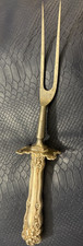 Silver colored carving fork