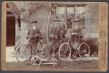 Three cyclists and boy with