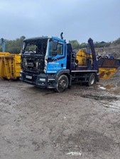 man skip lorry breaking