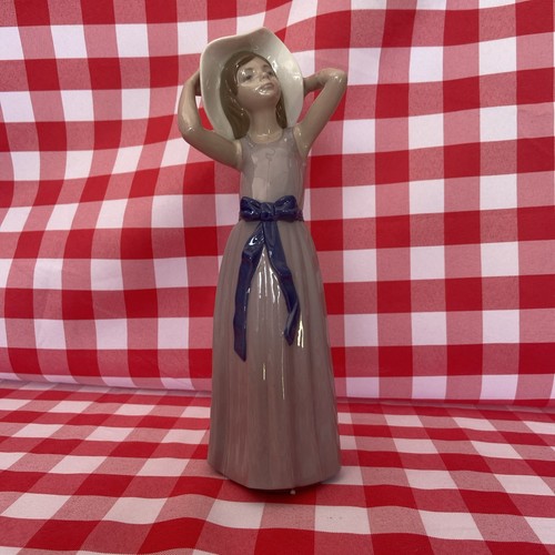 Lladro girl trying straw - trying, on