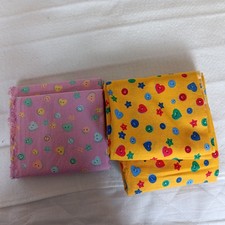 2 fabrics with button design yellow one approx 1 metre pink one approx 3/4 metre