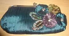 Emerald green  satin evening bag with embroidered flower detailing 