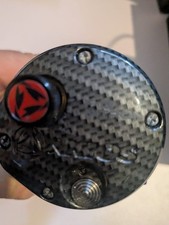 Akios Nitron F-15 Fishing Reel In A  Red And Carbon Frame