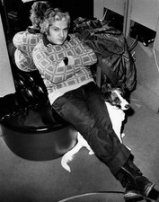 Singer Bruno Lauzi sitting a chair with her legs stretched under h- Old Photo