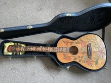 Blueberry parlour guitar with flower carvings