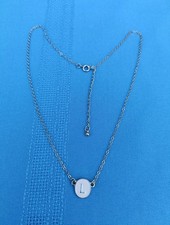 "L" Initial Pendant With Pink Background On A Gold Tone Chain.