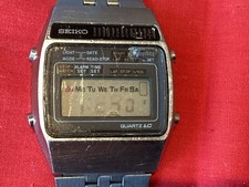 A VINTAGE SEIKO QUARTZ LC ALARM, A159-5009R. WORKING BUT DISPLAY FAINT, WORN