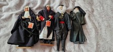 4 dolls in black clothing