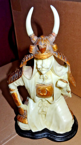 Carved resin figurine of a - ,