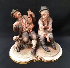 Capodimonte Figure group Two men on bench, one holding a Rabbit by Bruno Merli