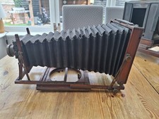 Antique folding plate camera, with Busch's rapid symmetrical F:8 lens, complete.