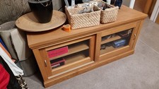 John Lewis solid oak TV storage unit with sliding glass doors. 