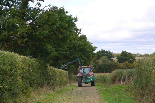 Photo hedge flailing an - hedge, on