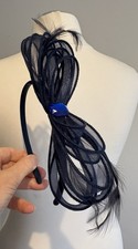 Navy fascinator with feathers on slim band good condition