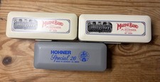 Three hohner harmonicas - g, &