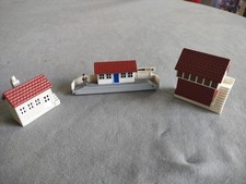 Miniature Fat Controller on station platform with signal box and other building