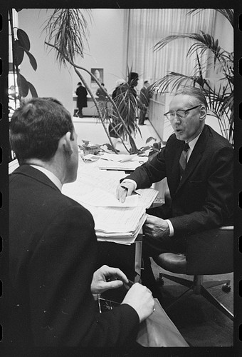 Man speaking with - [, a
