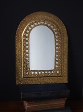 Vig mirror features an arched, Moorish design with intricate pierced detailing
