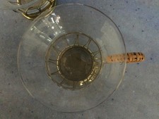 Two vintage glass and brass tea cups with wicker handles