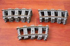 ELEVEN PIECES OF LEGO 9V CURVED TRAIN TRACK.