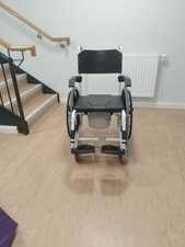 Self propelled shower commode