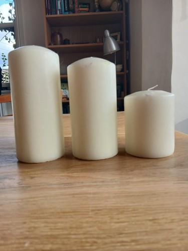 Three ivory pillar candles - three,